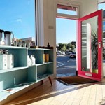 The entrance to the Corner Store through their bright red door.