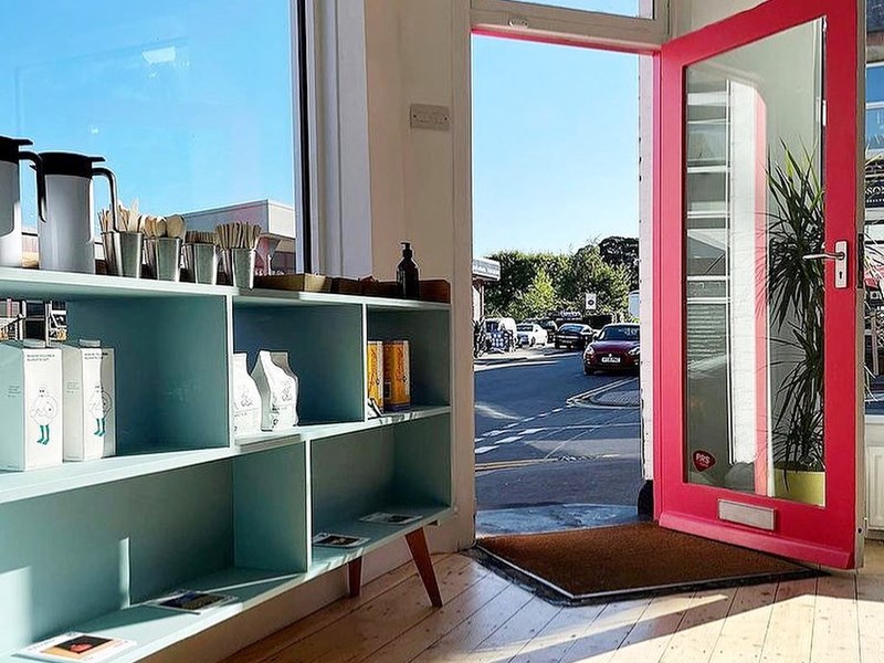 The entrance to the Corner Store through their bright red door.