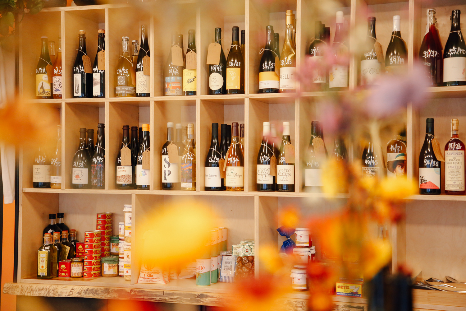 Wooden shelving filled with bottles of wine and spirits.