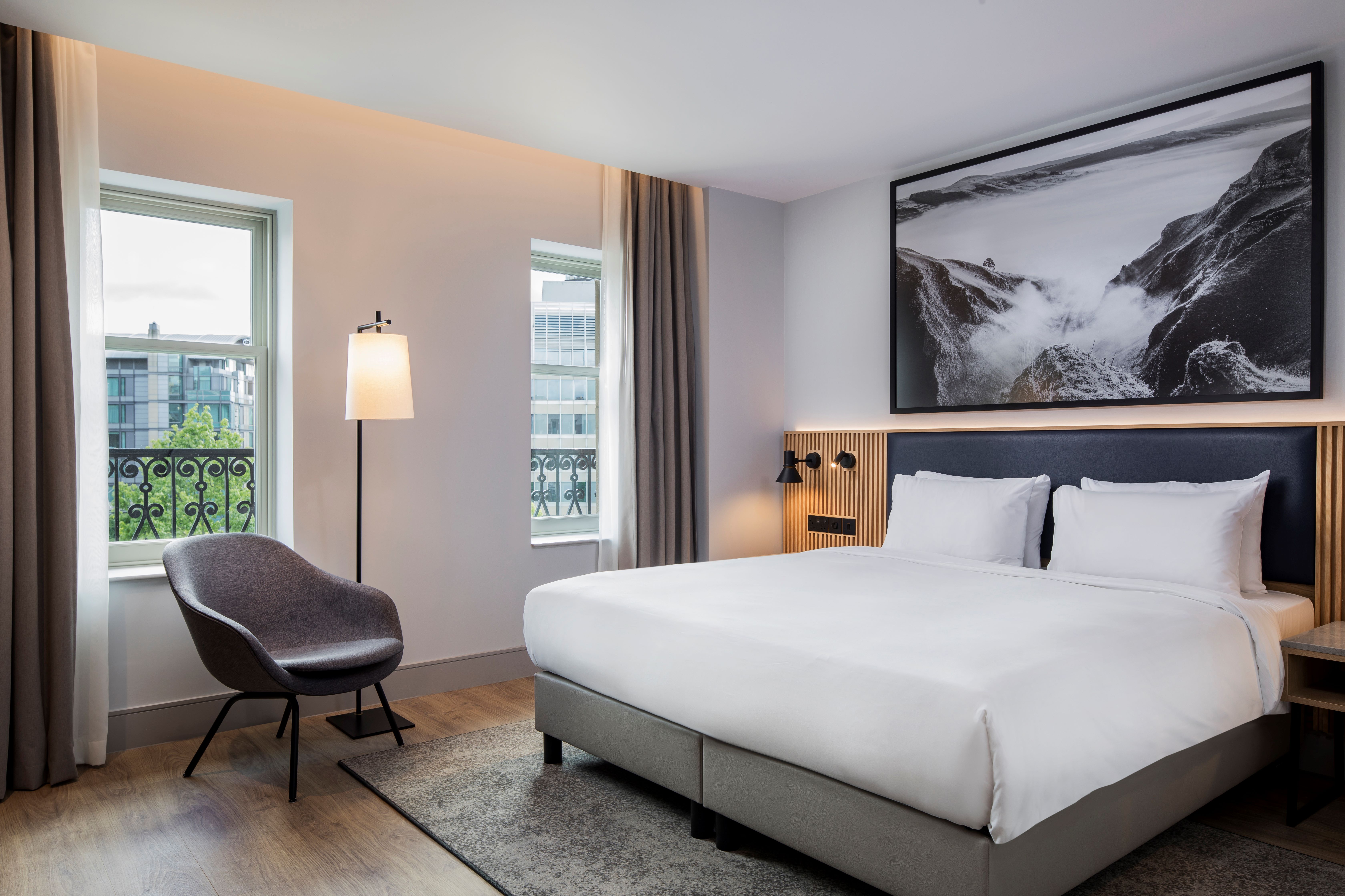 A hotel room with a double bed and quality furnishings.