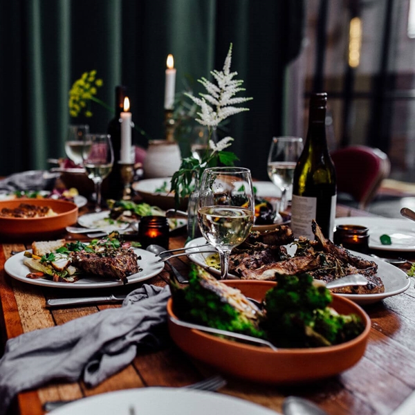 A table at The Mowbray full of food and wine.