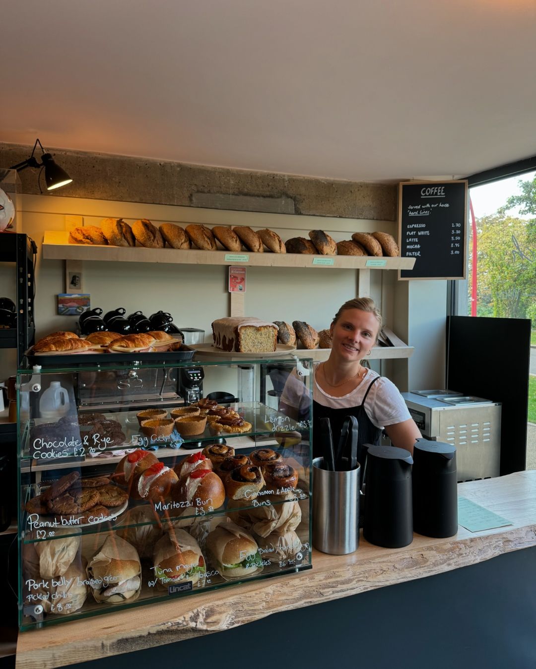 A member of staff behind the counter at Bench La Cave .