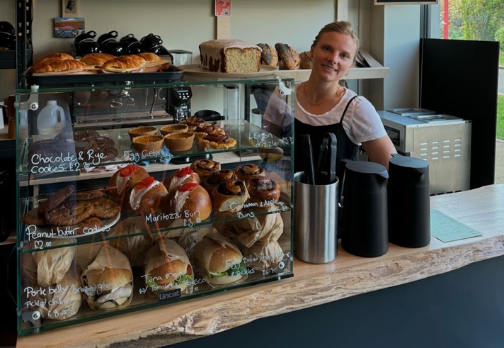A member of staff behind the counter at Bench La Cave .