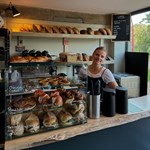A member of staff behind the counter at Bench La Cave .