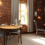 A table and chairs by a window.