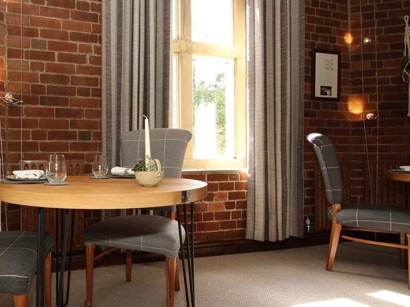 A table and chairs by a window.