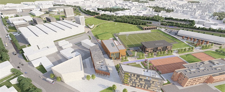 Group of seven people in a modern office lounge with colorful sofas and a wooden coffee table. A small plant sits on the table, and a large window behind them shows a brick building outside. A unique wooden bookshelf filled with books is visible on the left.