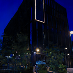 A painting of a building at night.