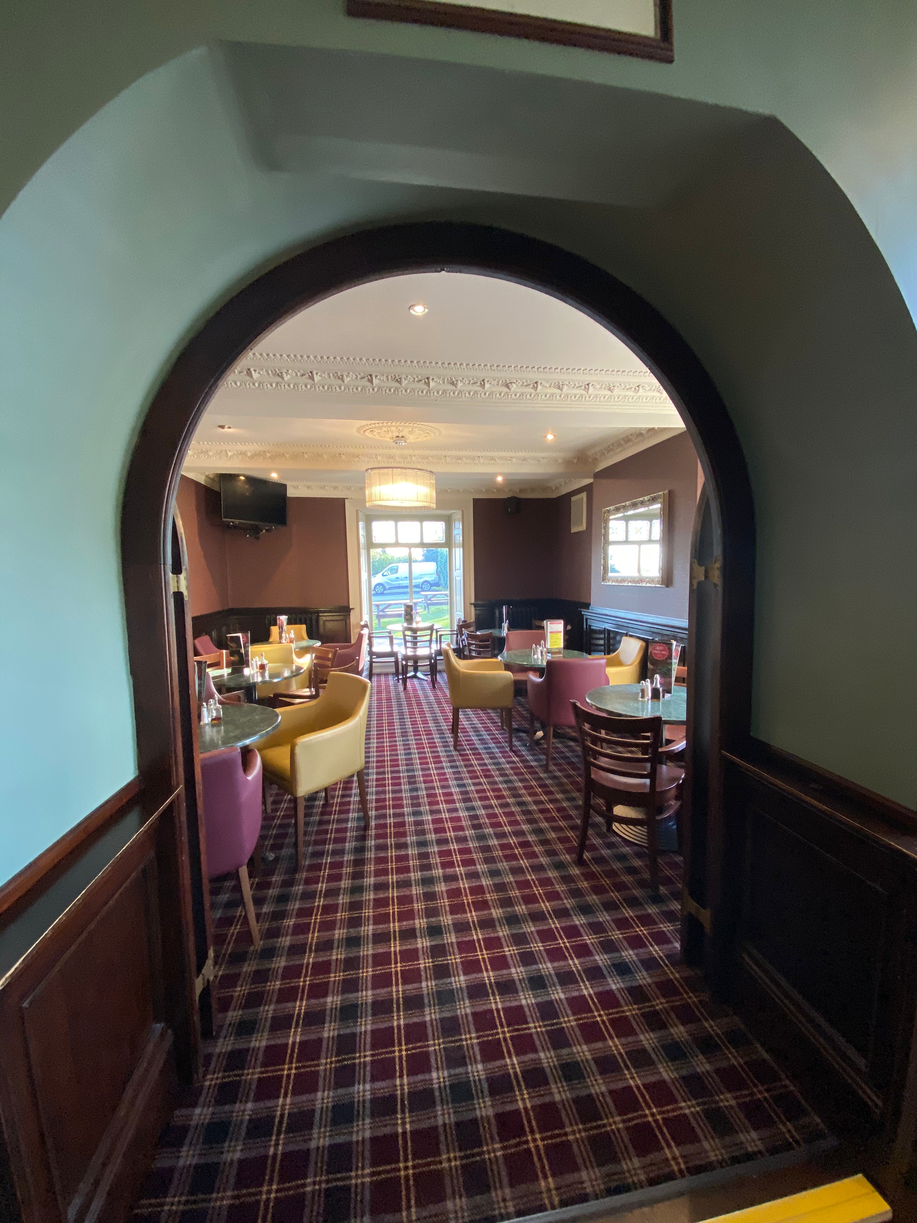 Breakfast room at Cubley Hall with tables, chairs, and natural light.