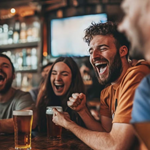 A group of young women and men laughing and enjoying some beers at the bar BOX Sheffield.
