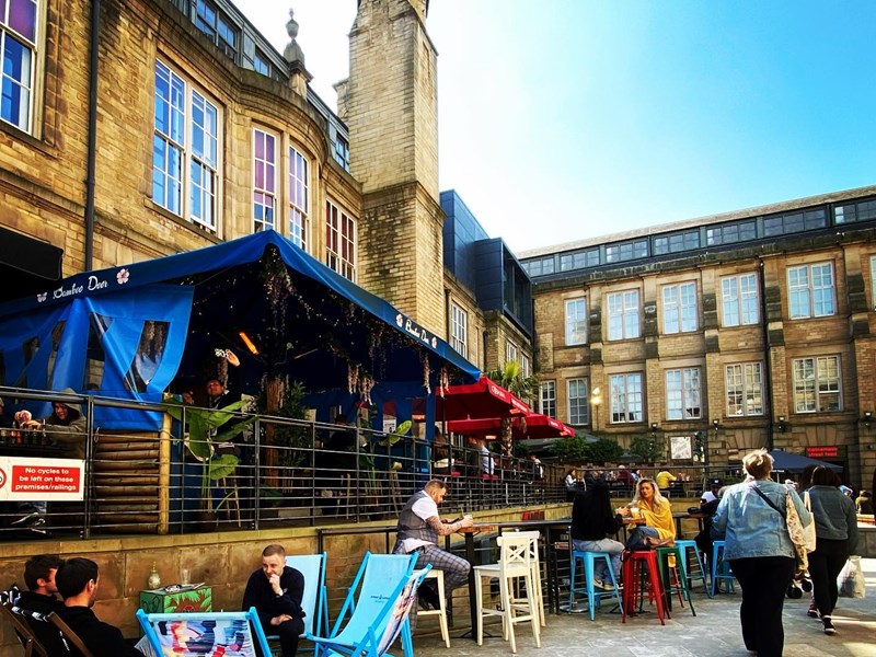 Seating in Leopold Square outside the Bamboo Door.