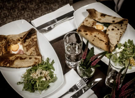An overhead shot of a table with plates of food at Inox Dine.