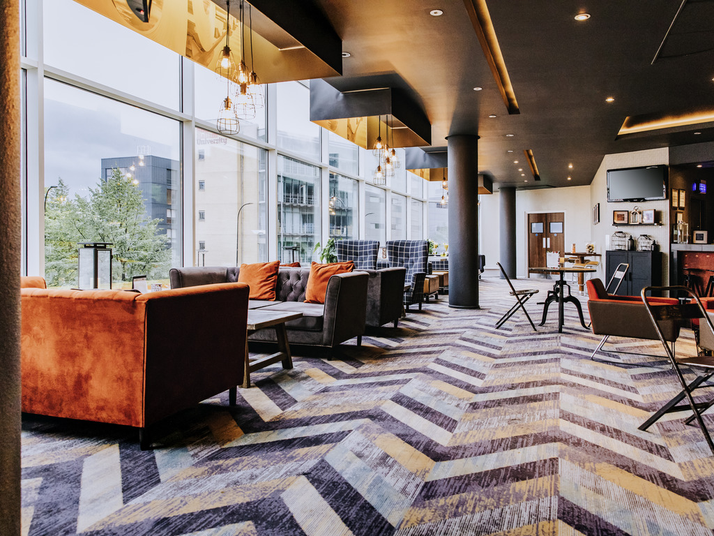 Contemporary bar area with large, comfortable seats and modern decor.