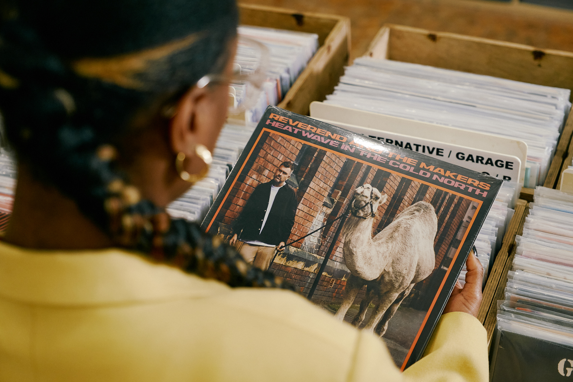 A woman looks at the cover of an album at Bear Tree Records in Sheffield.