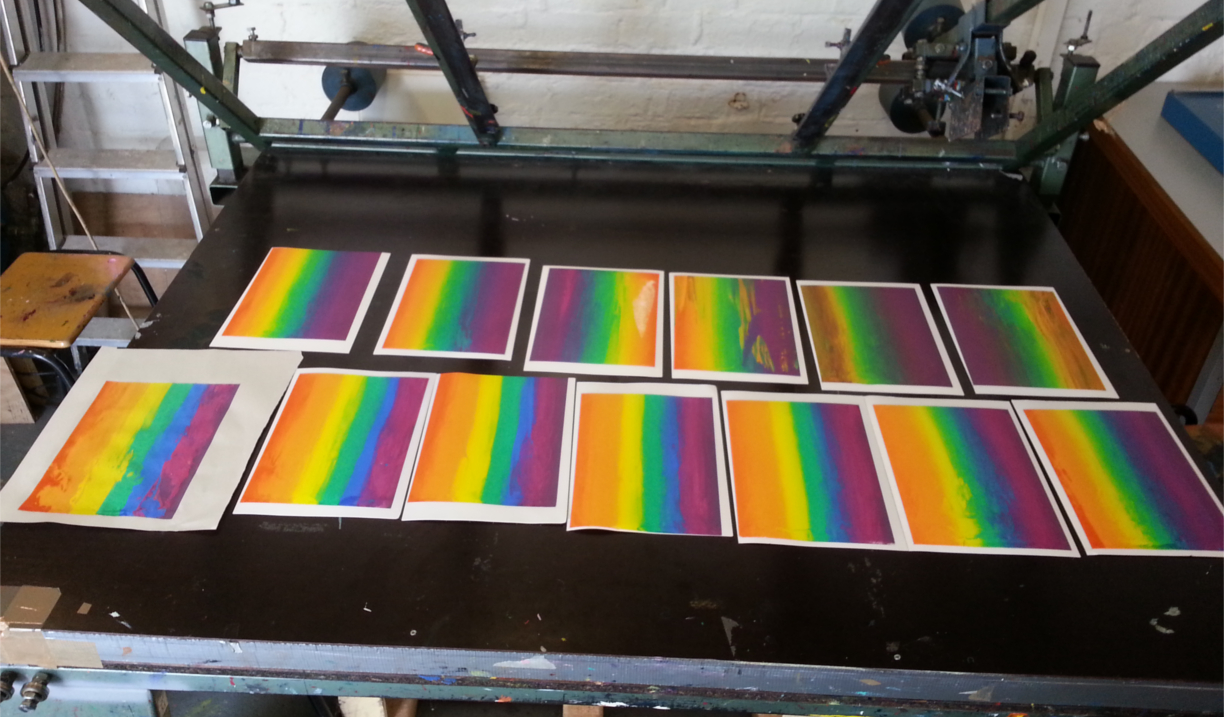 Multiple prints drying on a rack.