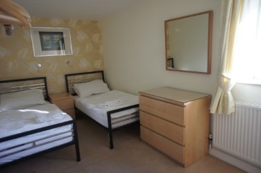 A twin room featuring two single beds and simple, cozy decor.
