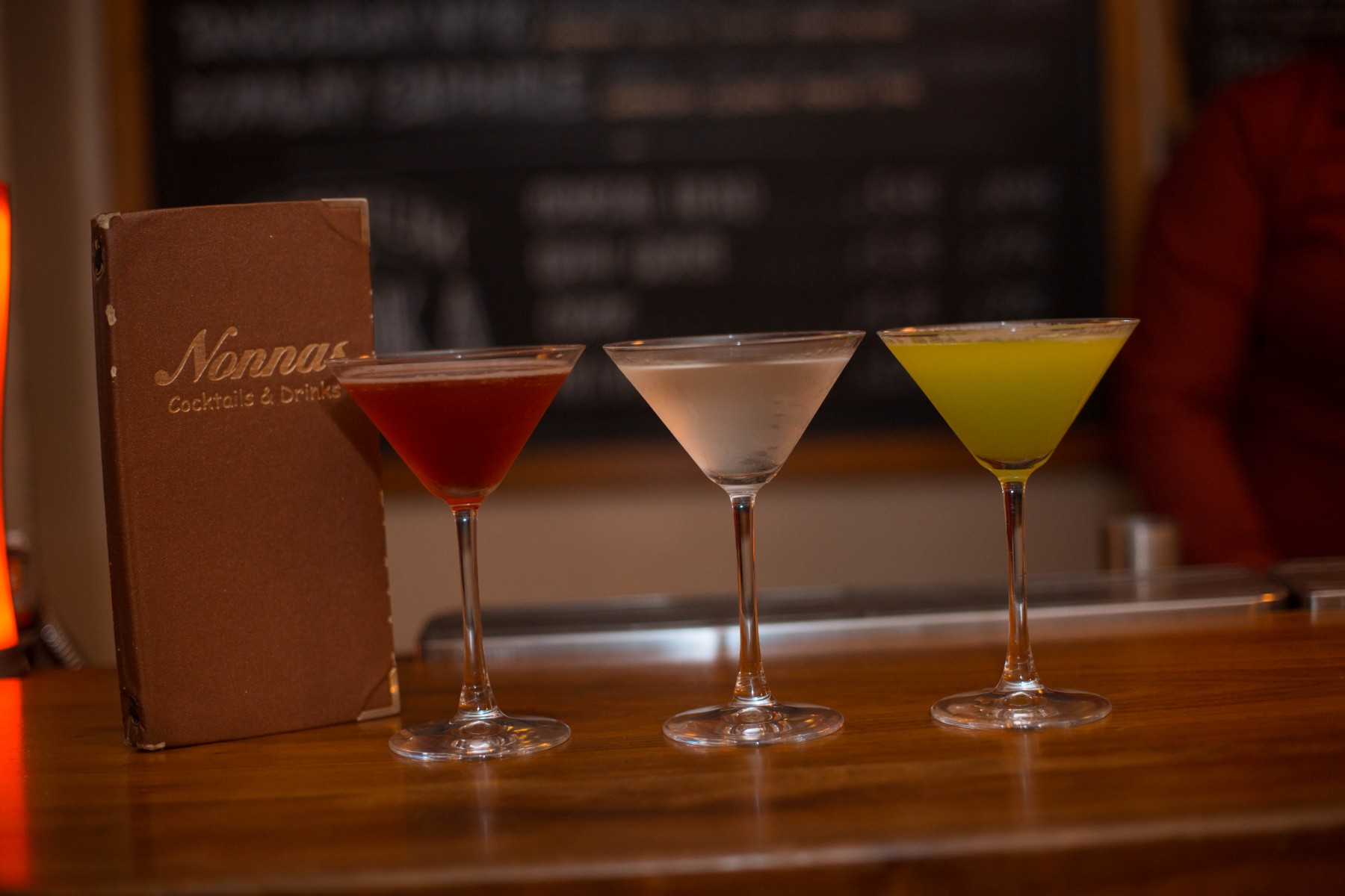 Three cocktails on a bar at Nonnas Restaurant.