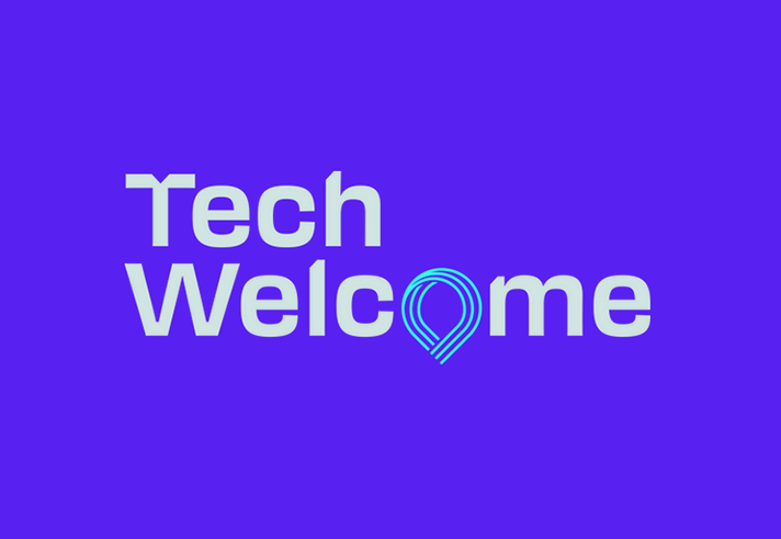 Logo design on a solid purple background featuring the words “Tech Welcome” in bold, light-colored text. The letter “o” in “Welcome” is stylized as a layered geometric shape resembling a location pin or abstract tech symbol in gradient blue tones. The overall design is clean and modern, emphasizing technology and connectivity.