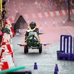A kart (styled as a WWII fighter plane) races down the track.