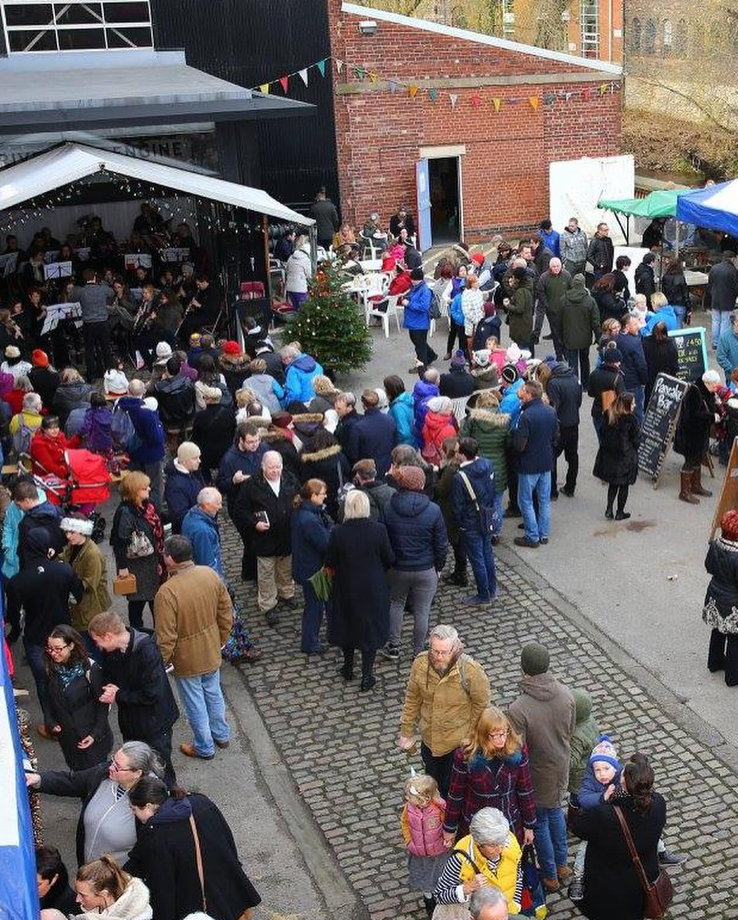 A crowd of people throng the Victorian Christmas Market at Kelham Island Museum.