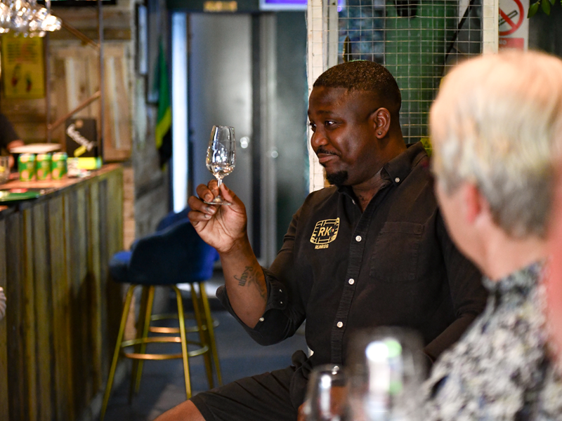 A man enjoying a glass of rum.