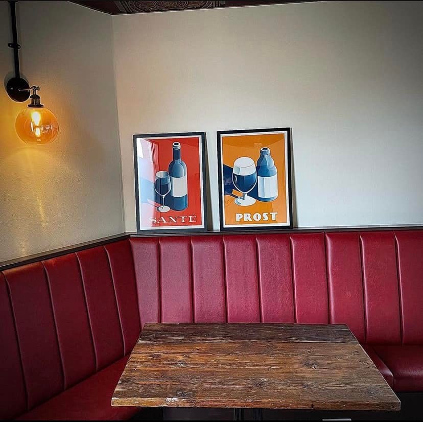 A corner booth at The Boston Arms upholstered in red leather.