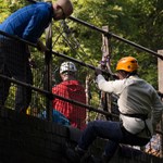 People abseiling off a bridge.