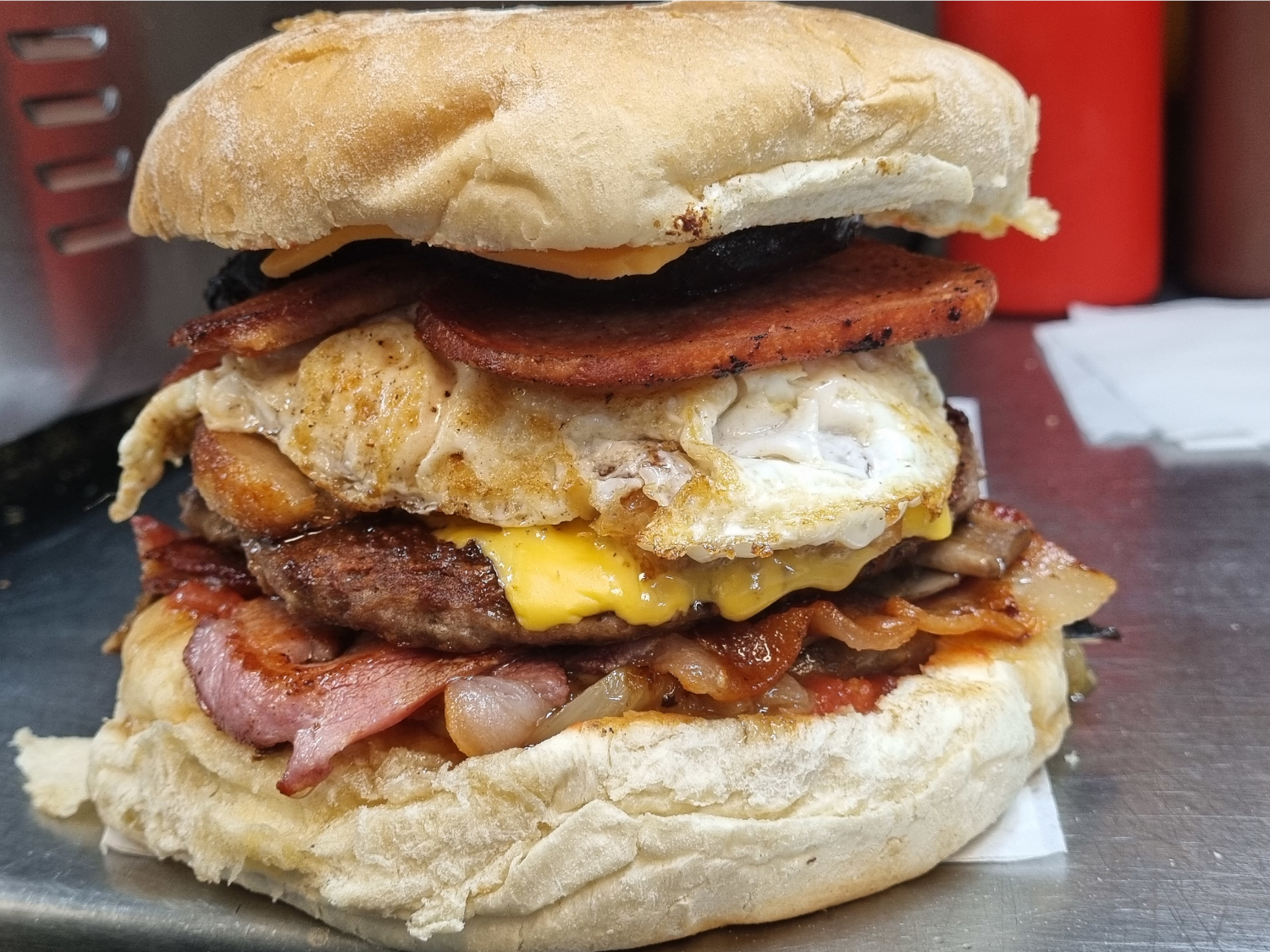 Full English breakfast piled up in a breadcake.