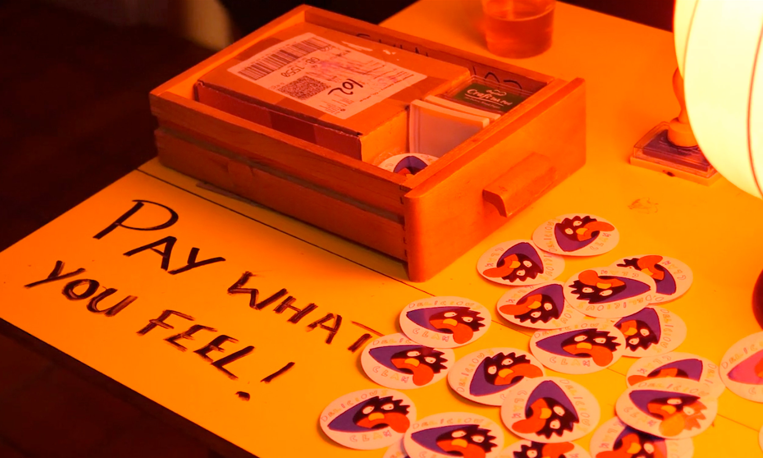 A merch table at Delicious Clam.