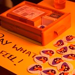 A merch table at Delicious Clam.