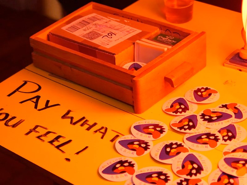 A merch table at Delicious Clam.