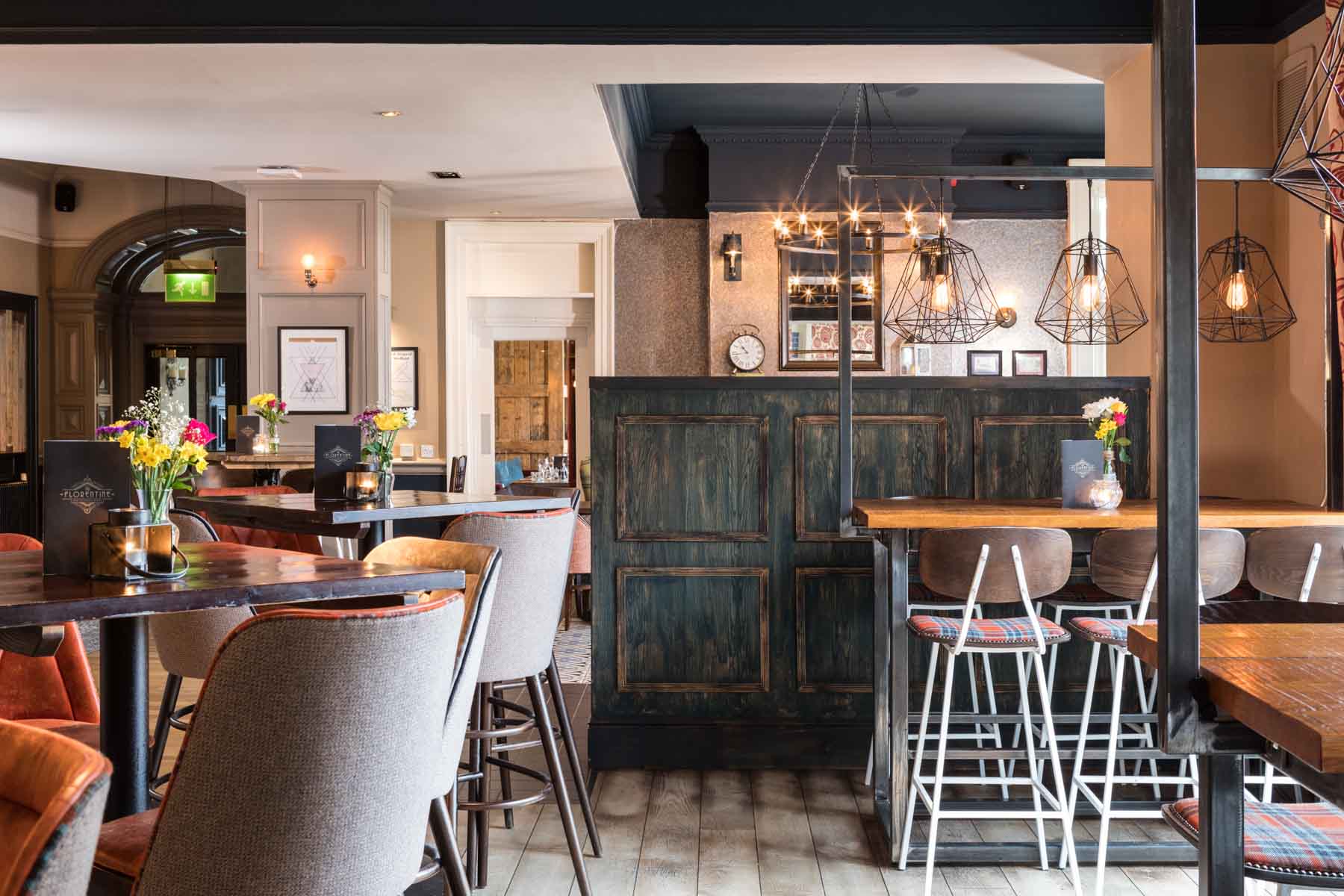 Charming bar area at The Florentine with wooden counter, ambient lighting, and seating