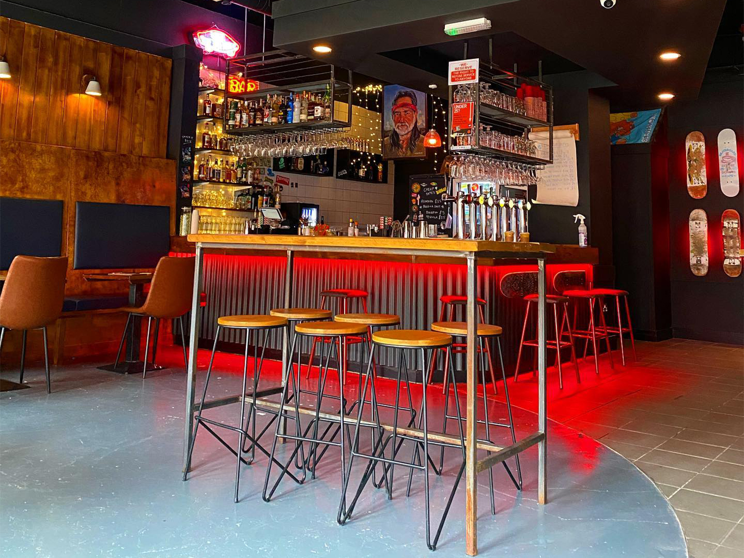 The bar at Cheap Dates, lit up with red lighting.