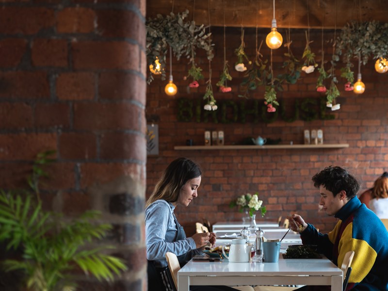 Two people dining at the Birdhouse Tea Bar & Kitchen.
