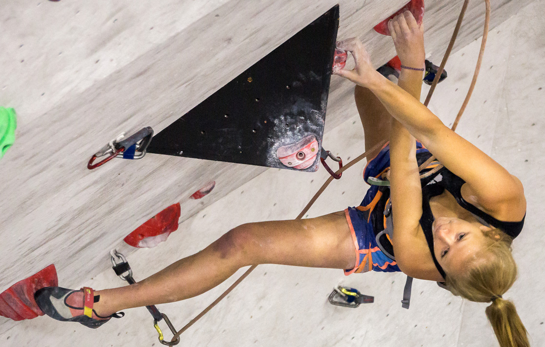 A woman on a climbing wall.
