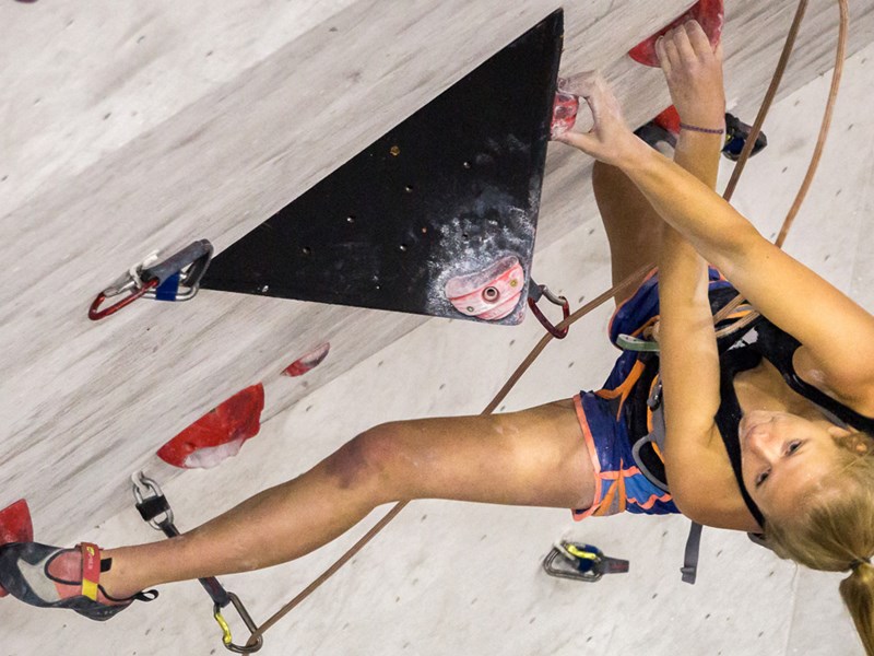 A woman on a climbing wall.