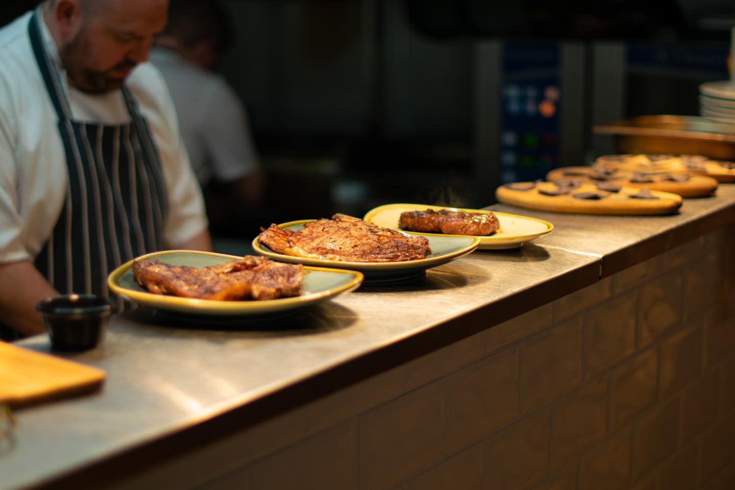 Rows of dishes on a counter top waiting to be served.