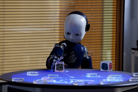 A blue humanoid robot with a white face developed by Sheffield Robotics.
