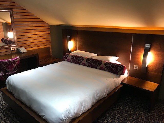 Double bedroom with a large bed, bedside tables, and cozy lighting.