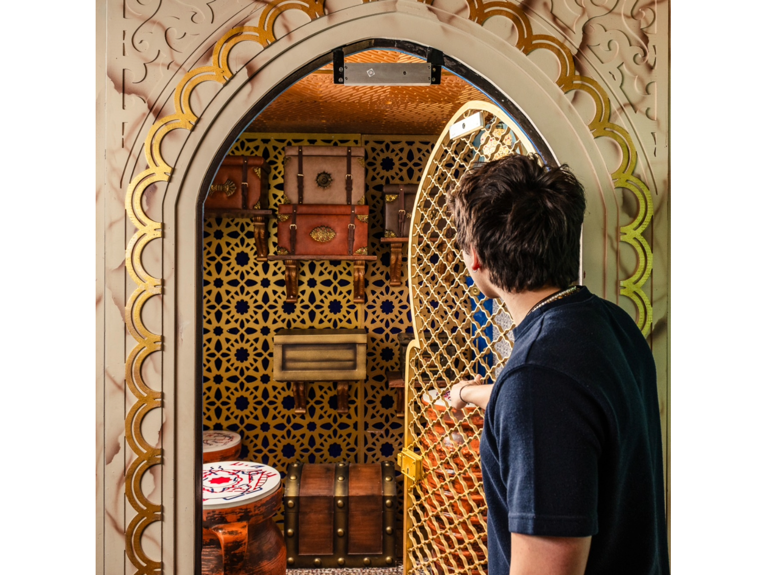 The Jewel of India escape room at Escape Hunt Sheffield. A man opens a door onto a mystical room.