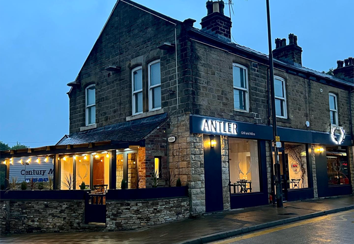 Exterior of The Antler at night.