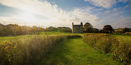 Sheffield Manor Lodge turret house and its lush surrounding gardens.