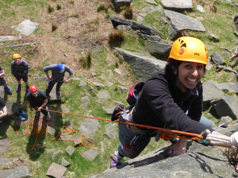 People learning to climb a rock face.