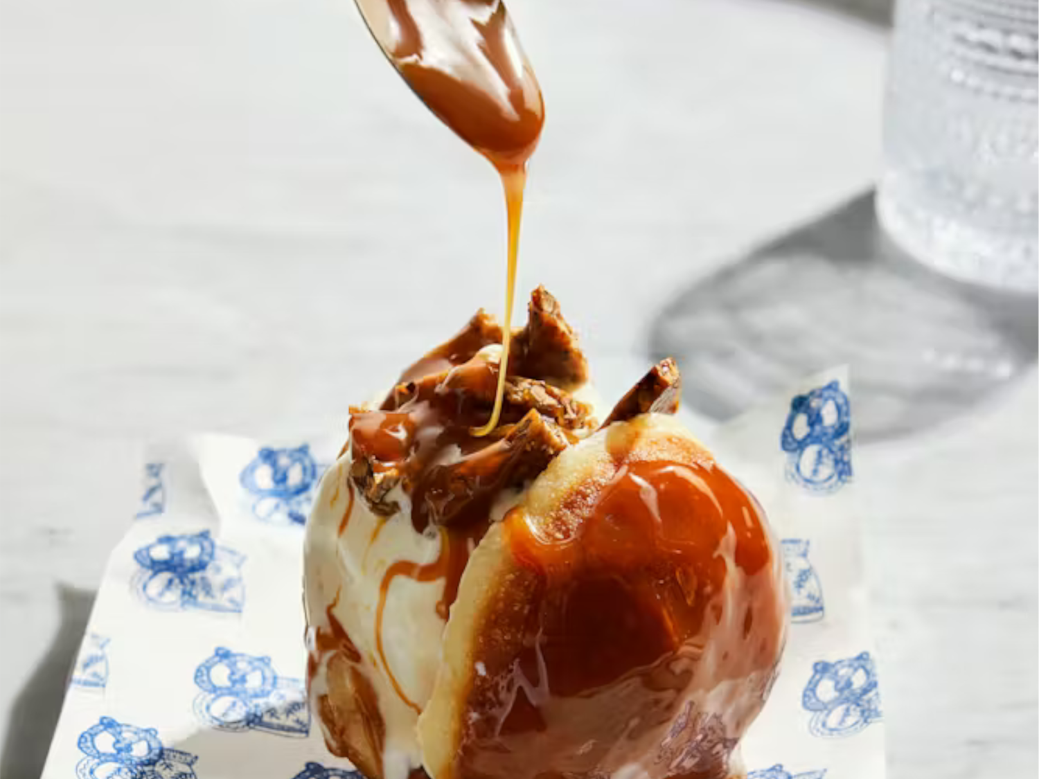 Toffee sauce being dribbled onto a dessert.