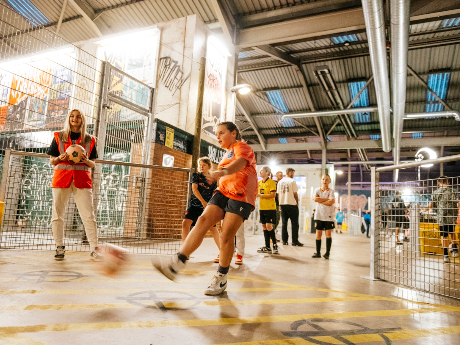 Children playing football at Yard Ball, an indoor football park.
