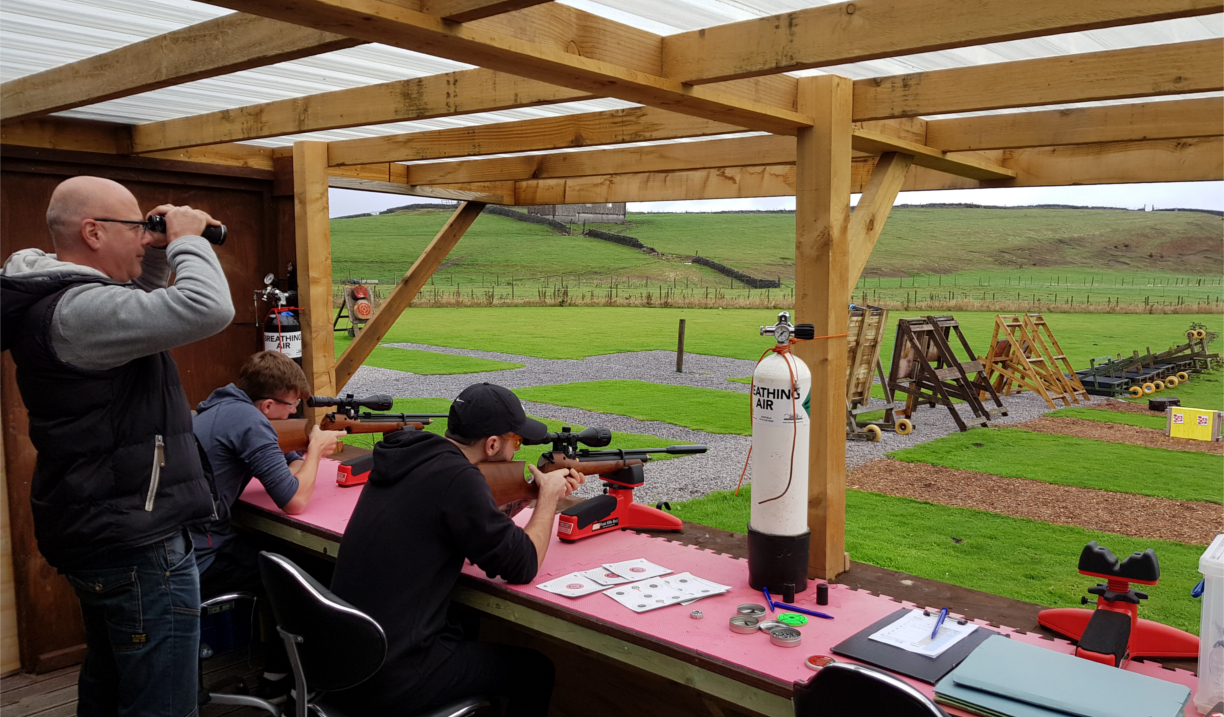 People firing rifles at targets.