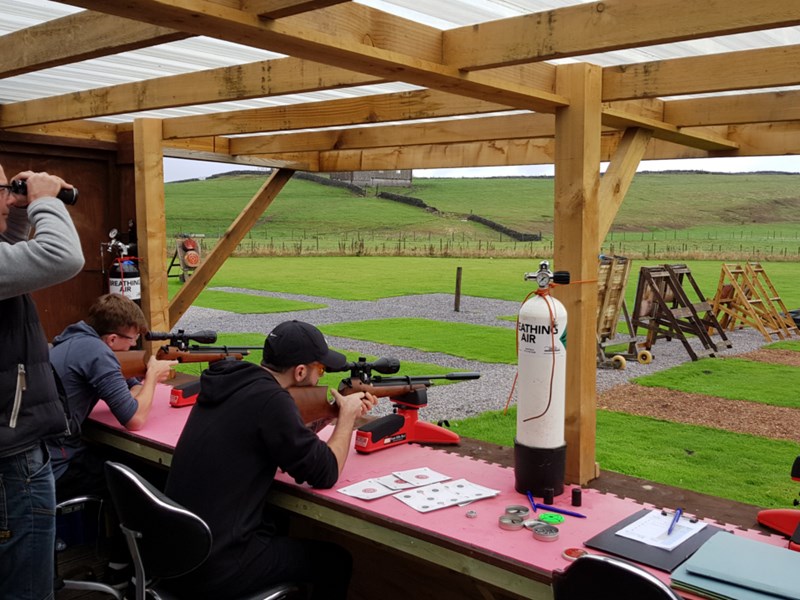 People firing rifles at targets.