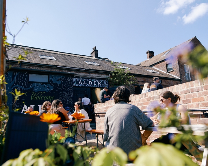 People enjoying the sunny exterior of Alder Sheffield in Kelham Island