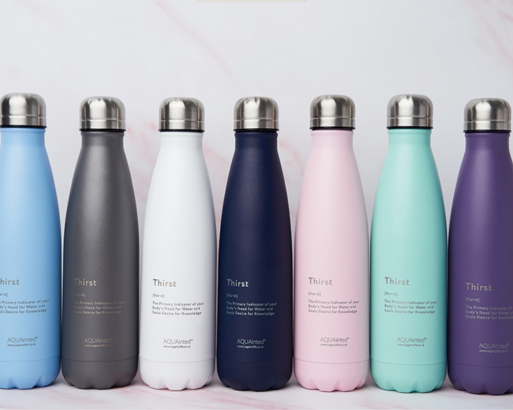 A row of seven metal water bottles in various colours.