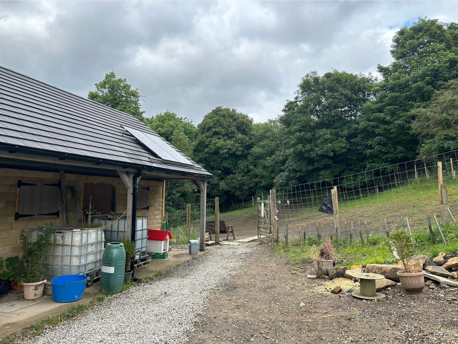A wooden building with a covered veranda at Rivelin Valley Dog Park.